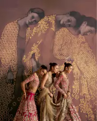 Luxury Bridal Couture – Conceptual Fashion Campaign – Amnah Sikandar Design Studio Luxury bridal couture editorial featuring three models in red and gold embroidered lehengas with artistic patterned backdrop. - Carousel Frame 13